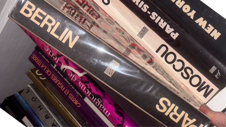 Collection of travel guide books on a shelf 