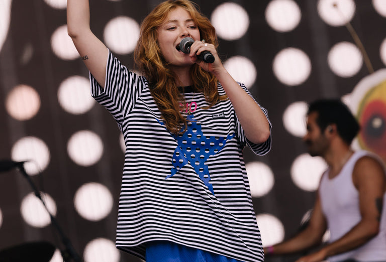 person performing wearing a striped shir
