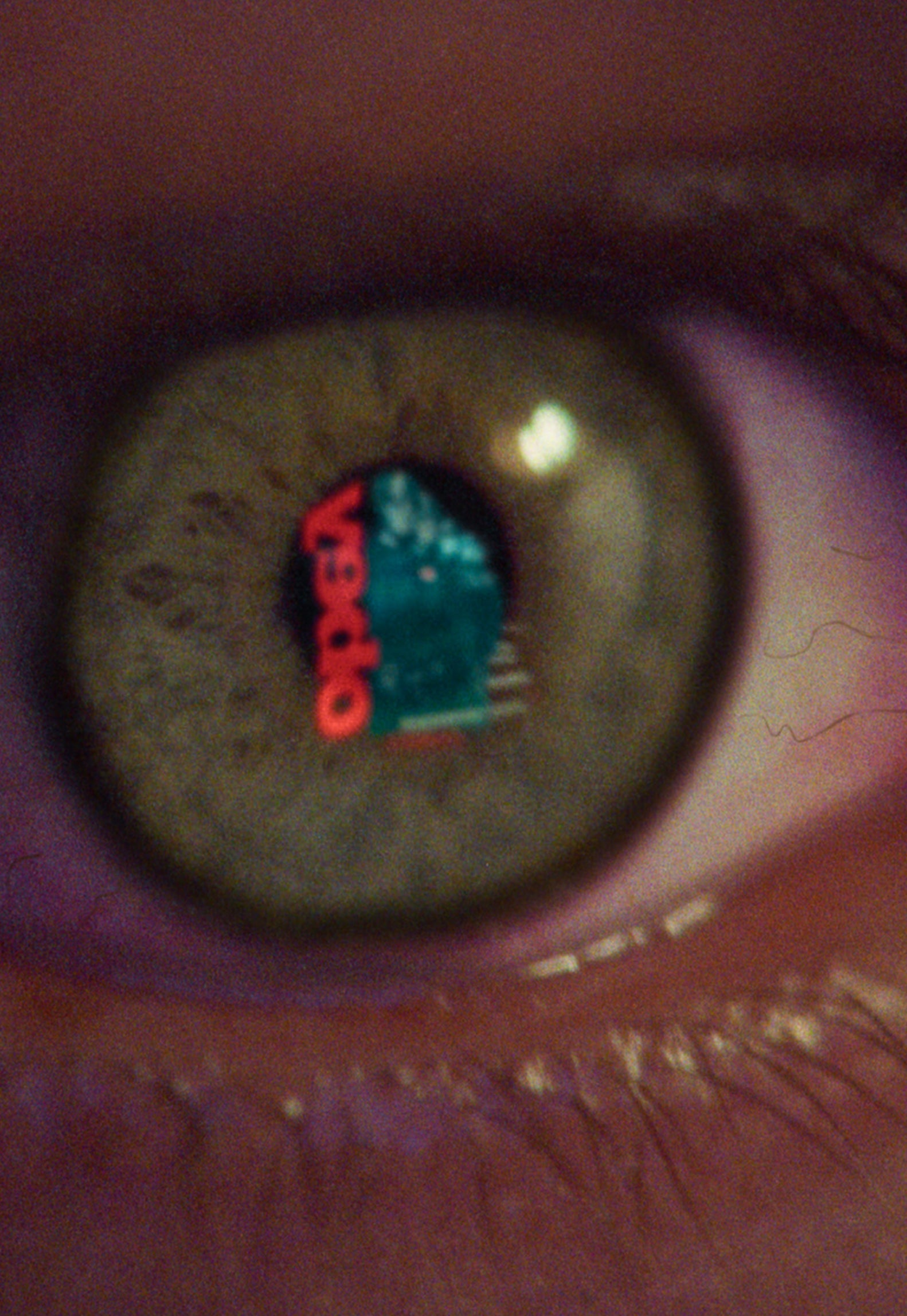 Extreme close-up of a human eye with a tiny vector artwork visible on the iris.